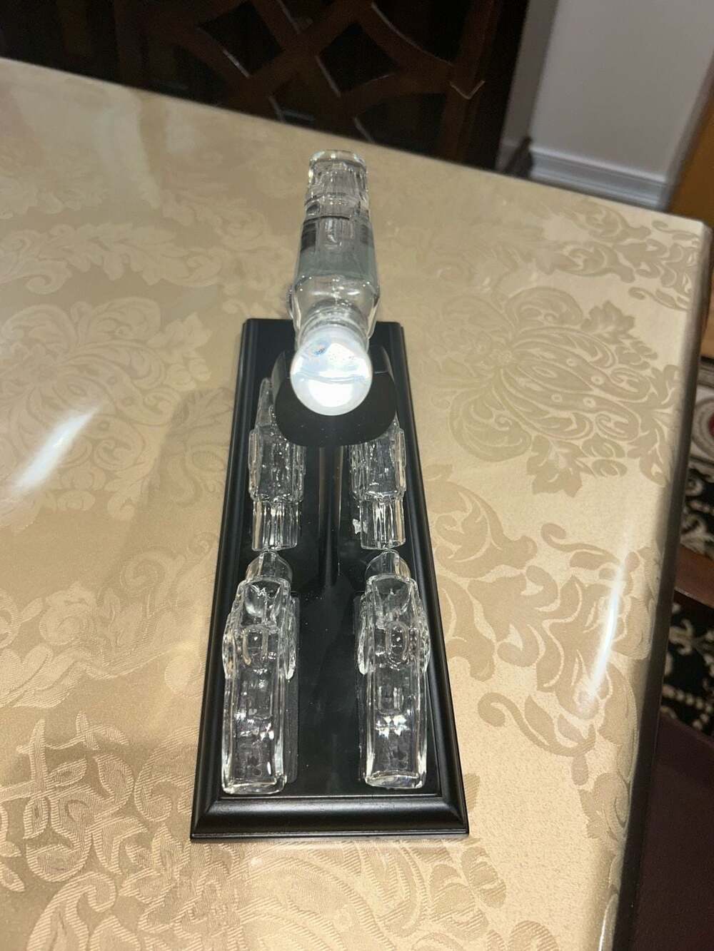 Clear Glass Pistol Decanter Set with Four Glass Shot Glasses on Display Stand
